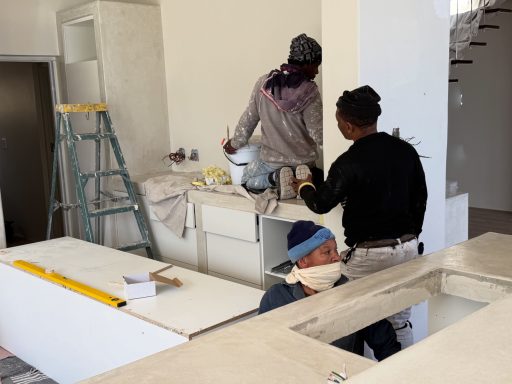Craftsman applying plaster finish to interior walls during the renovation of MBIZI lagoon house