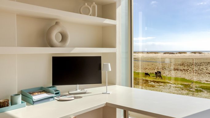 Workspace with desk and lagoon view at MBIZI lagoon house