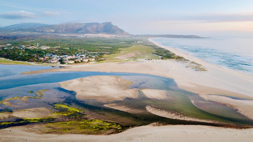Bot River Lagoon at dusk with mountains and natural coastal vegetation near Hermanus, South Africa