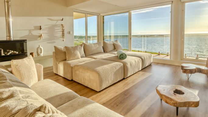 Open living area with comfortable seating and natural light at MBIZI lagoon house, Hermanus