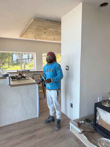 Local craftsman using power tools during the interior renovation of MBIZI lagoon house, Hermanus
