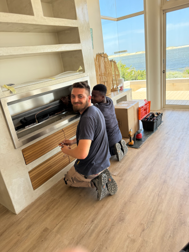 Construction worker installing new flooring during the renovation of MBIZI lagoon house, Hermanus